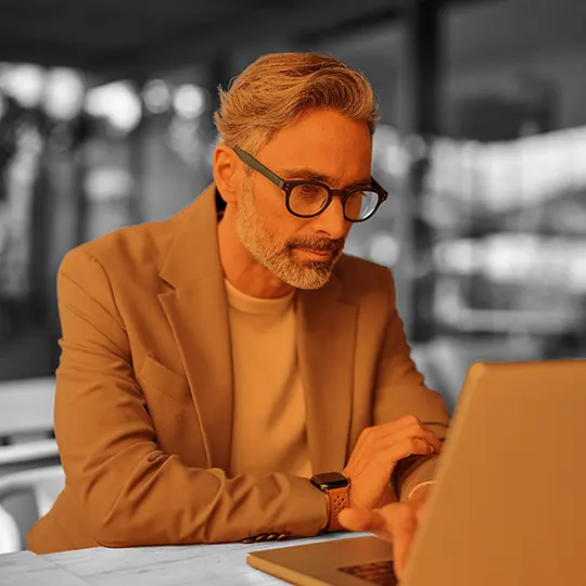 Private investigator researching on laptop