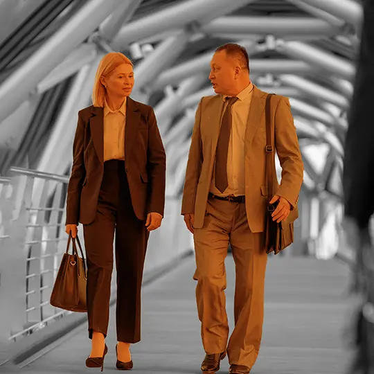 Private investigator and business client talking while walking down a hallway